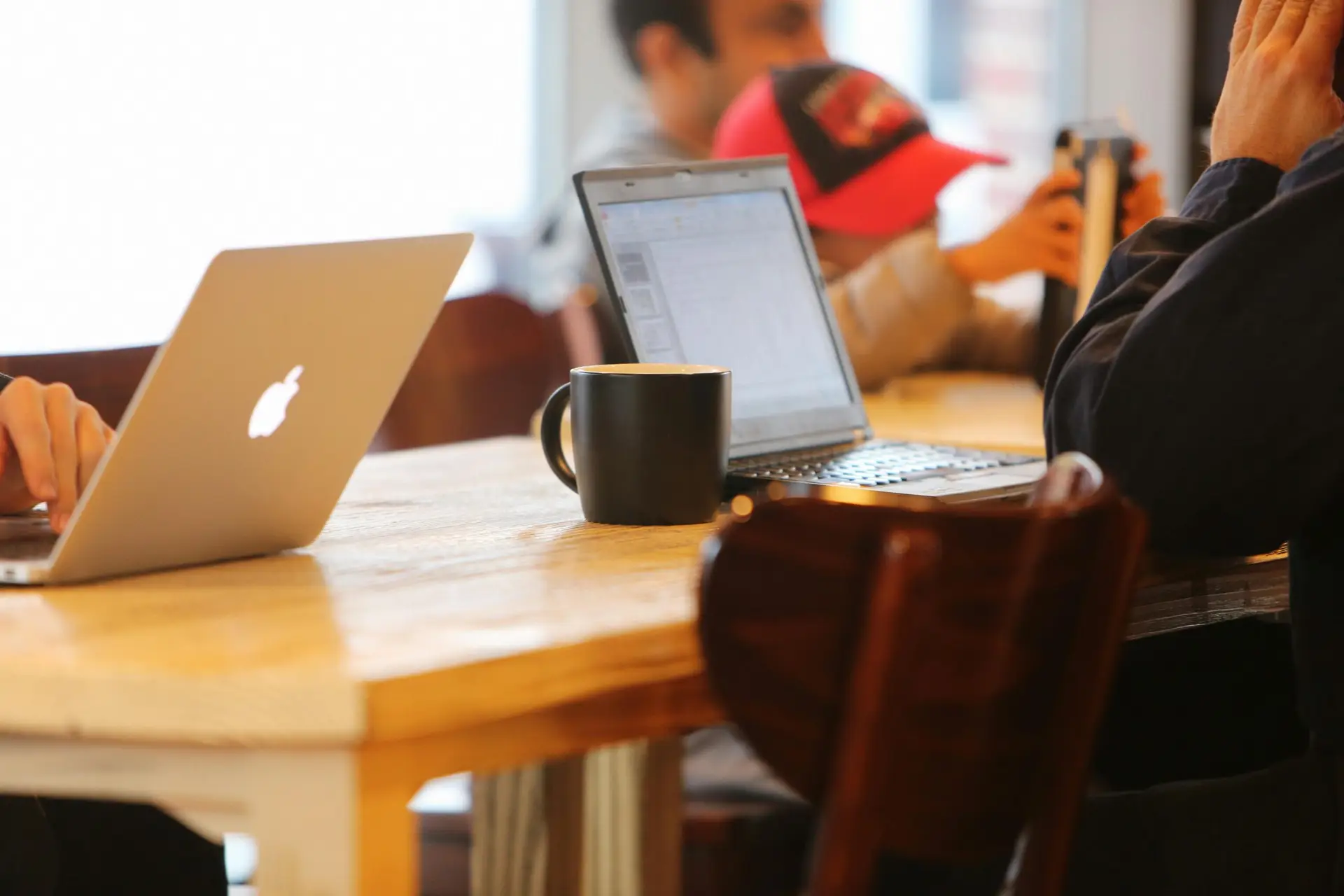 a team of VAs sitted with laptops on the desk