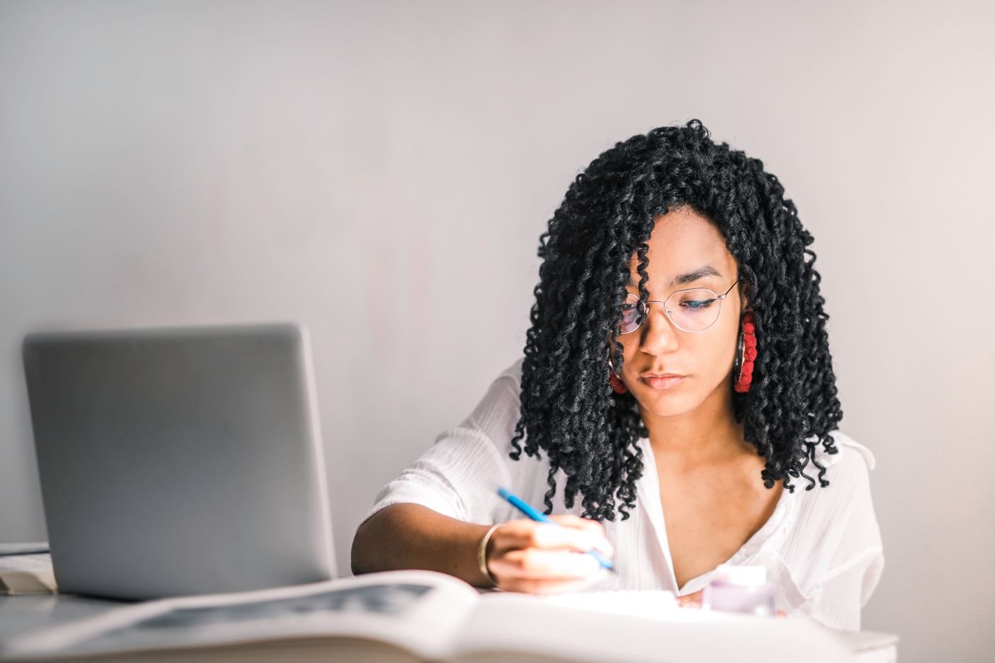 A business owner reading and planning at her desk
