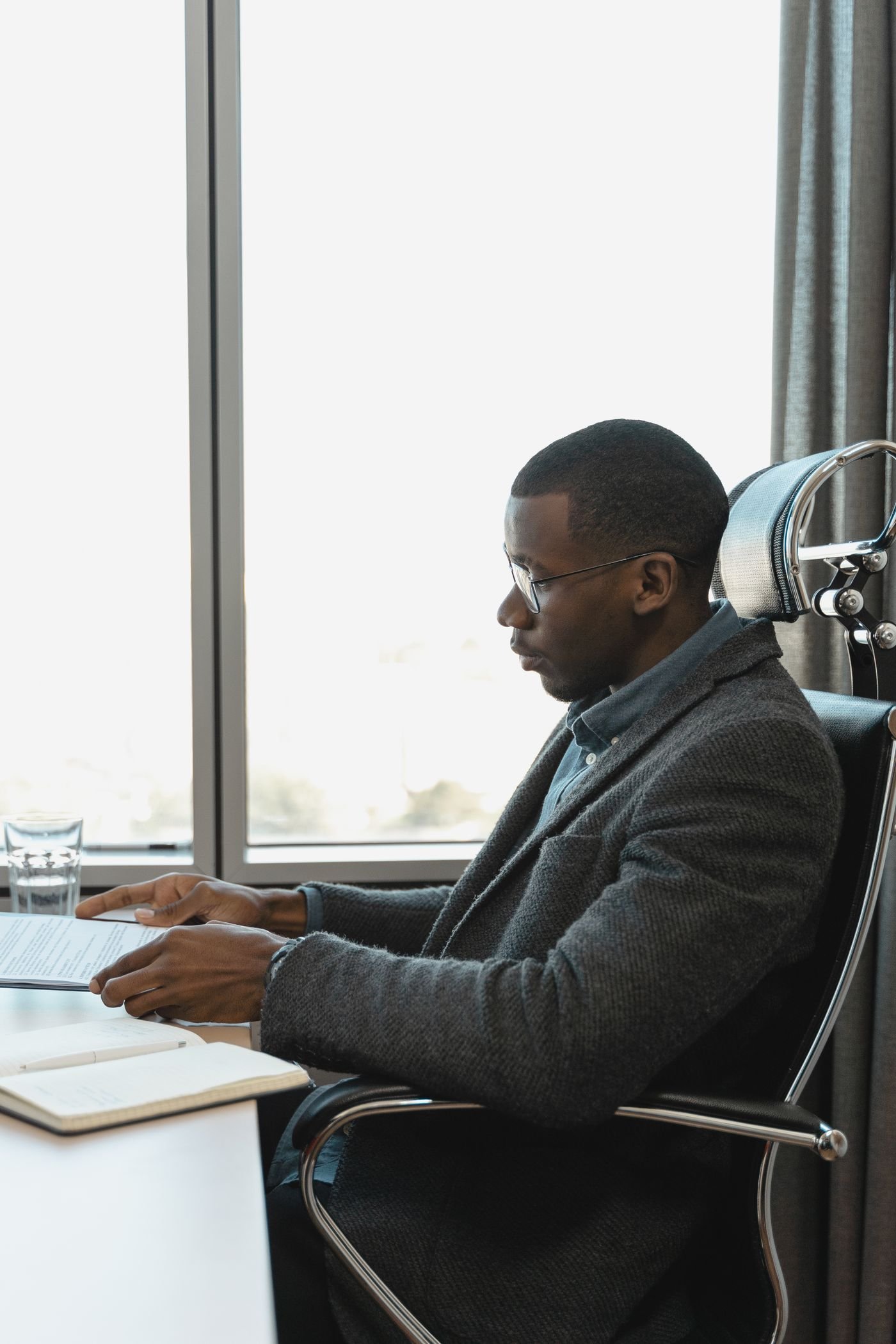 Two colleagues working together at a laptop reviewing information