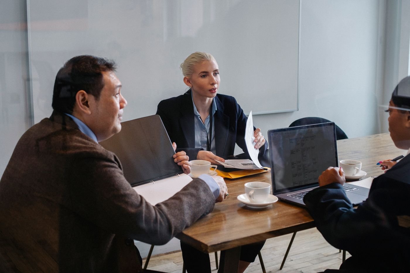 Two women in a consultation meeting, one listening attentively